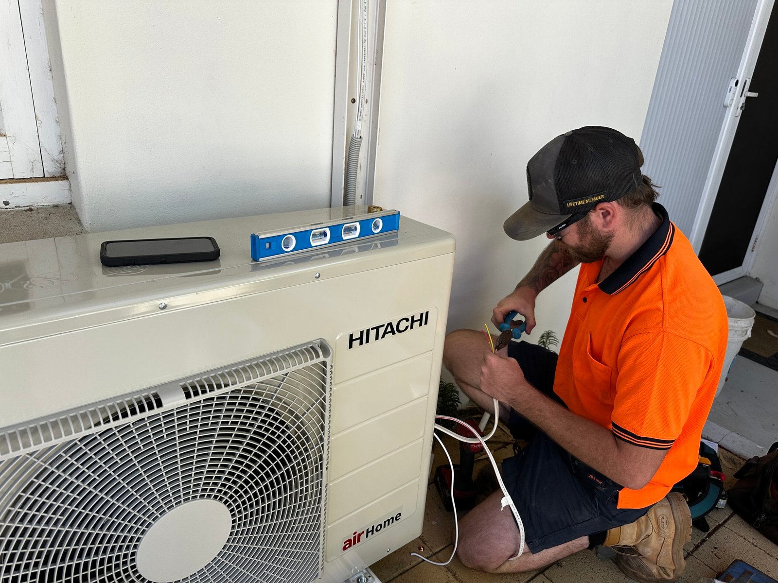 ECG electrician making air conditioning installment and repair in a house
